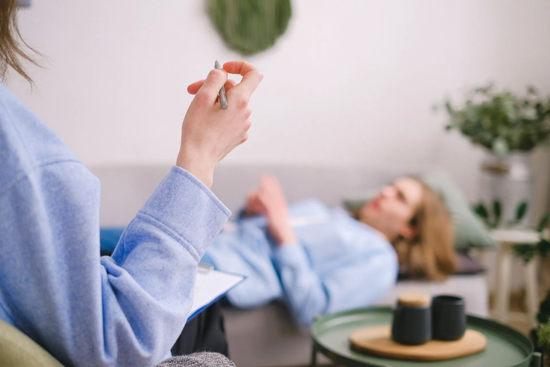A hypnotherapy session in a calm, sunlit room